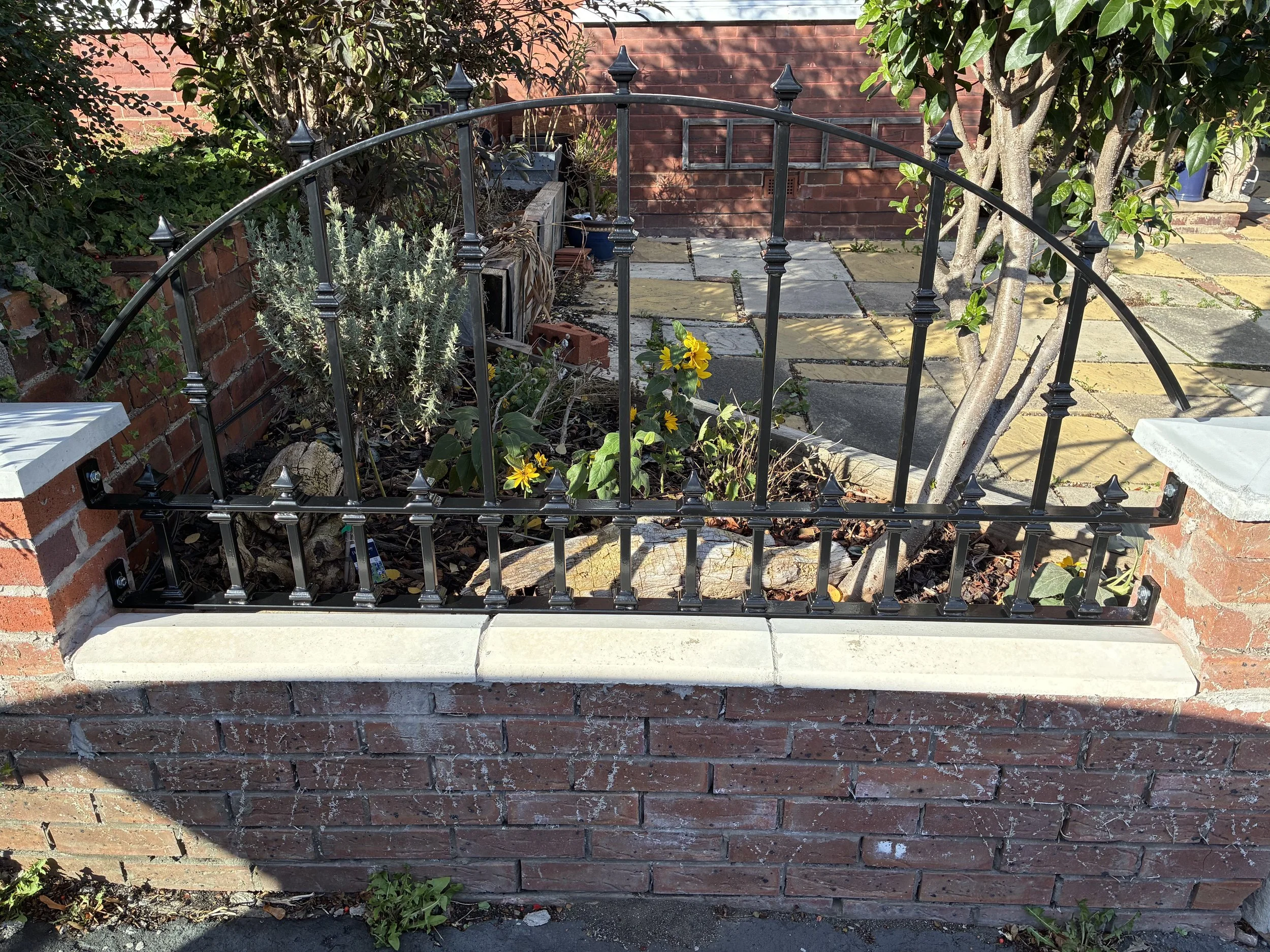 Bespoke Victorian-style wrought iron railings with an elegant arched top design, manufactured and installed by Sharland Steelworks in Wakefield, West Yorkshire. Traditional decorative steelwork combining heritage-inspired styling, quality craftsmansh