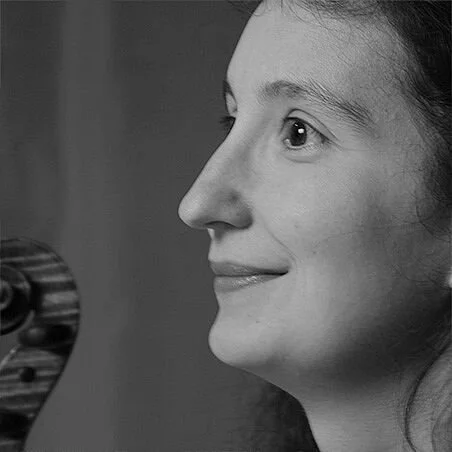 Close-up profile of a woman with a gentle smile in black and white.