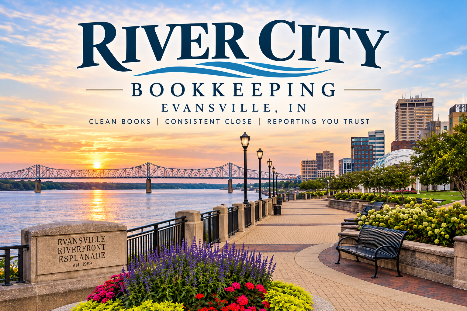 Sunset over the Evansville Riverfront Esplanade in Evansville, Indiana, with a bridge over the river, a paved promenade, lampposts, benches, green trees, flowers, and city buildings in the background.