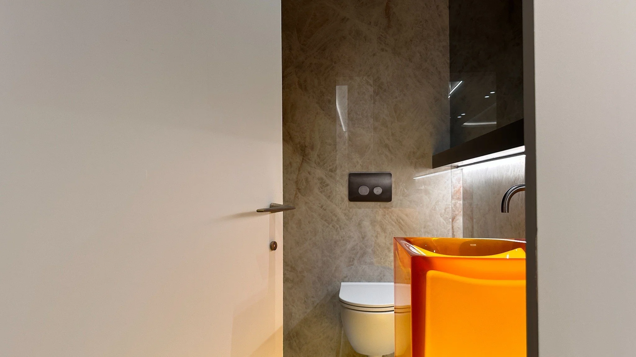 Powder room with sculptural antonio lupi in the Eton residence by Chrome Design in Montreal