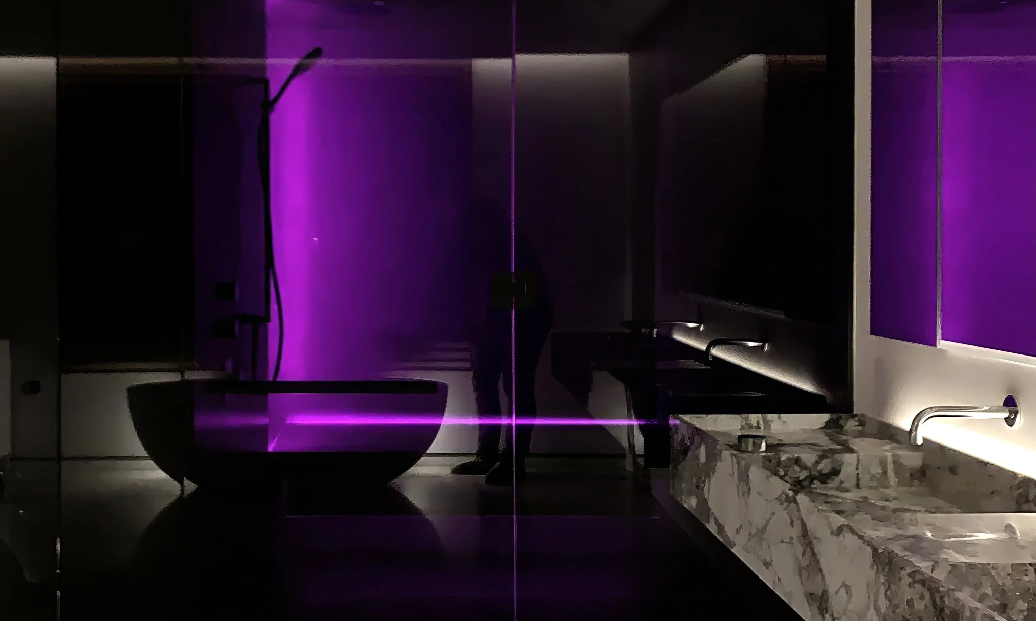 Lazard primary bathroom with dramatic purple lighting by Chrome Design in Montreal