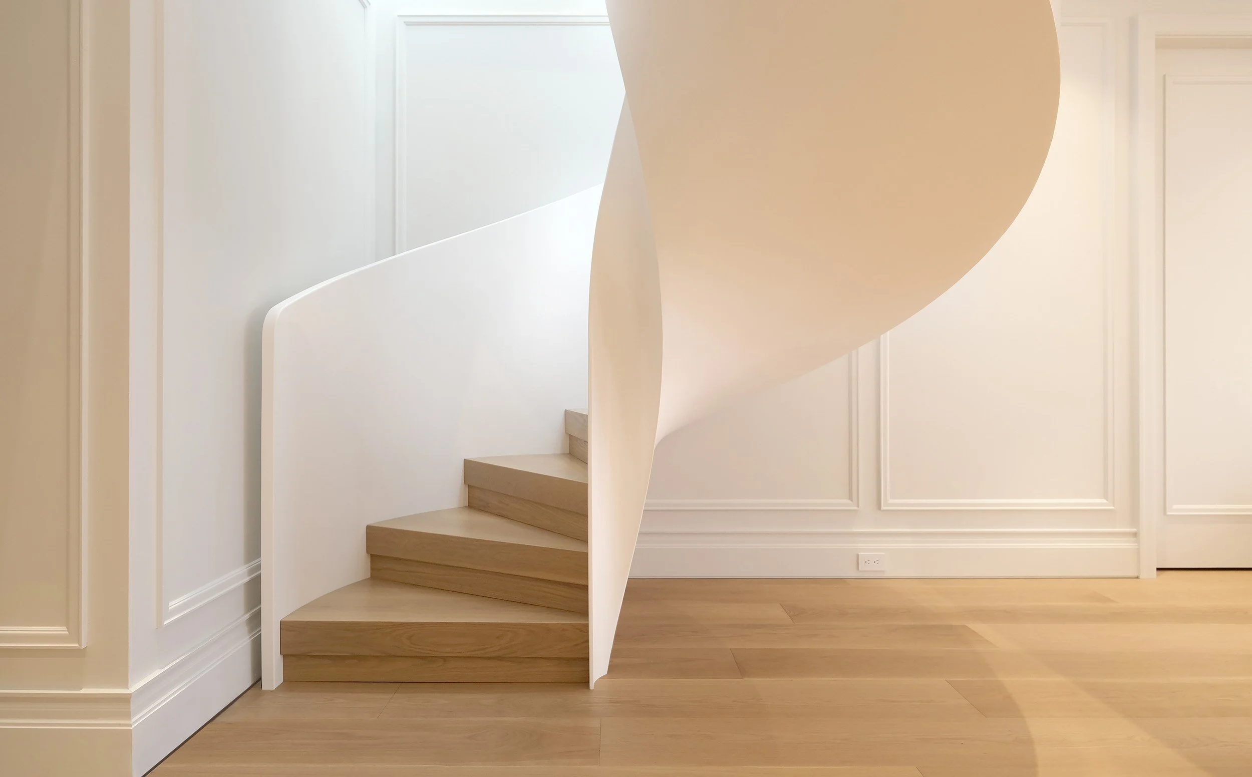 Sculptural spiral staircase in the French Velours penthouse by Chrome Design in Griffintown, Montreal