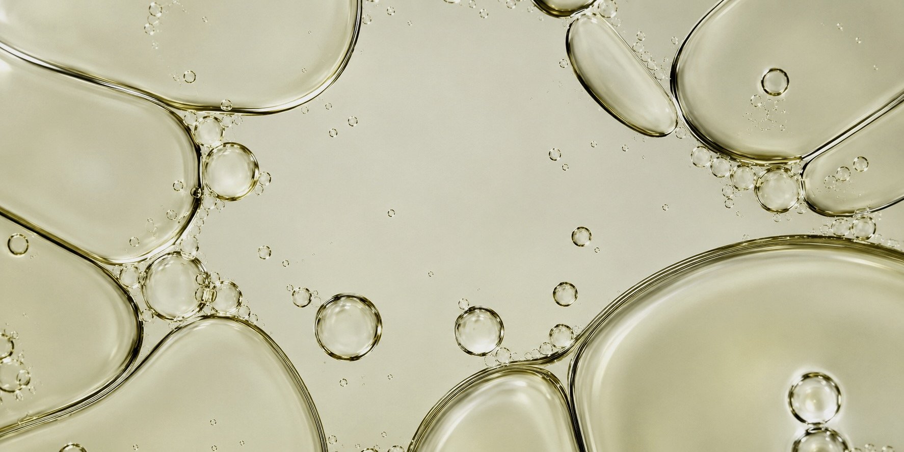 Close-up of translucent oil droplets in water