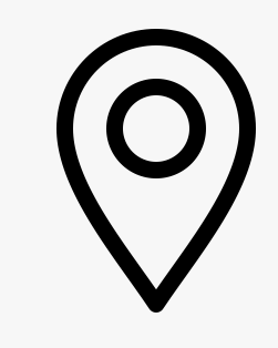 A simple black and white icon of a map location marker