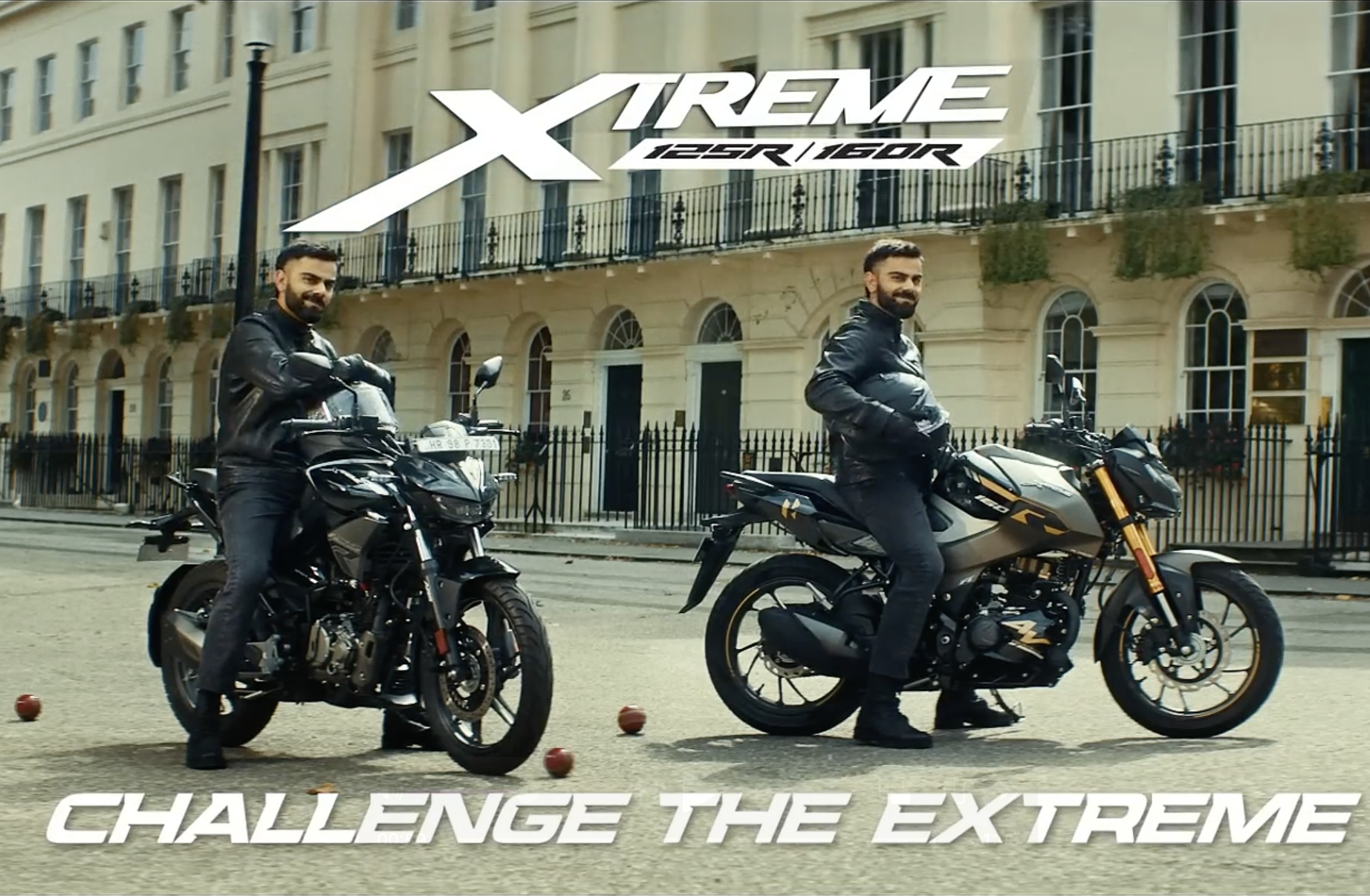Two men on motorcycles in front of a row of buildings with balconies. The man on the left is on a black motorcycle, and the man on the right is on a gray motorcycle. The text overlay reads 'Xtreme 125R/160R' and 'Challenge the Extreme'.