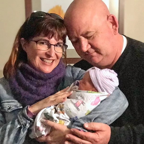 photo of grandparents holding baby