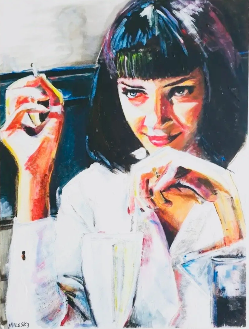 A portrait of a woman with short dark hair, holding a cigarette with one hand, and resting her chin on her other hand. She has a slight smile and is wearing a white top.