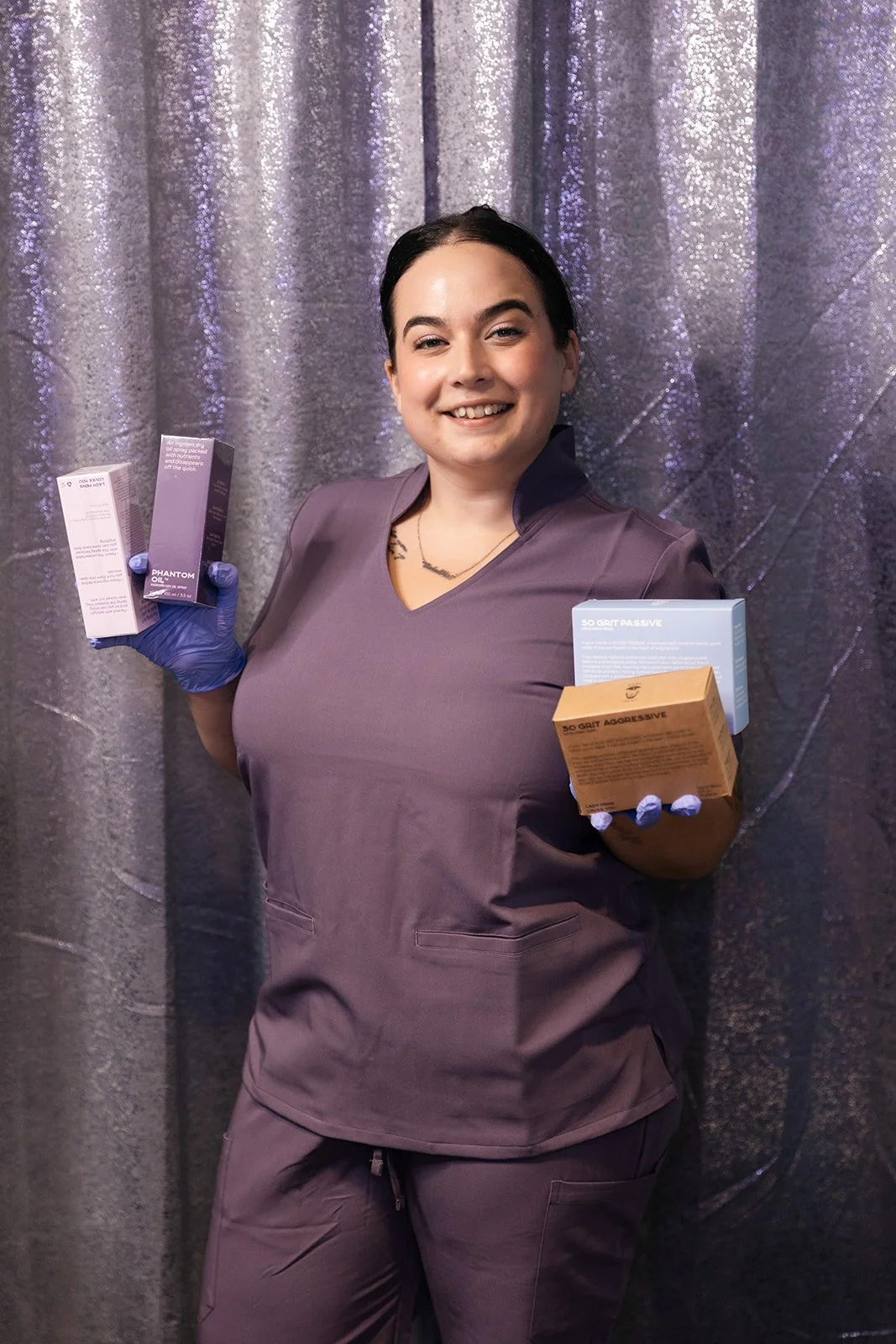 Wax specialist holding professional waxing aftercare and exfoliating skincare products