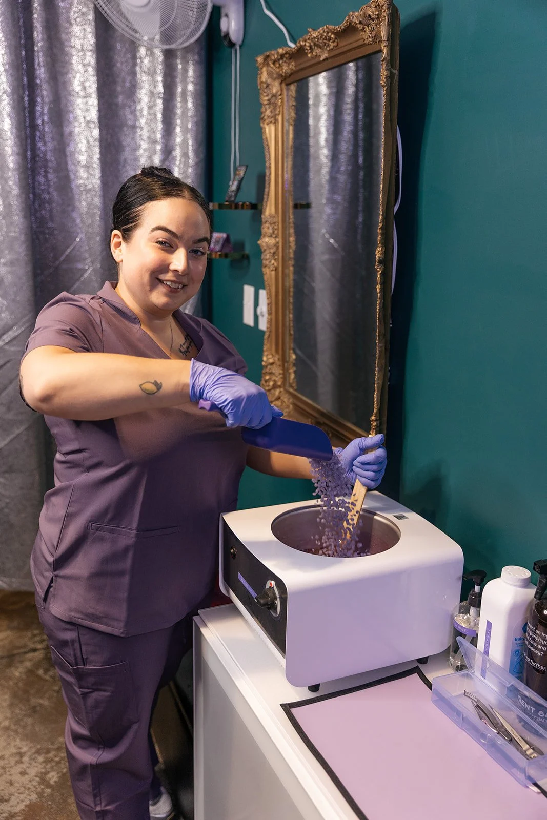 Wax specialist preparing hard wax beads for professional waxing services