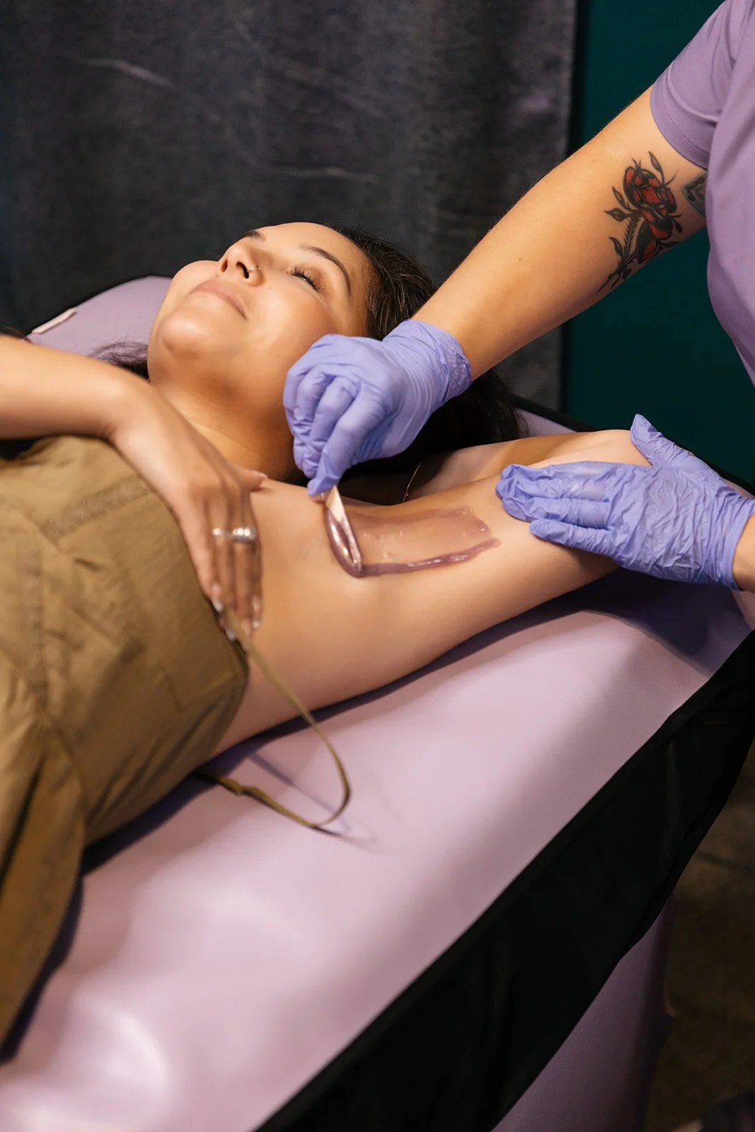 Close-up of wax being applied during a professional body waxing service