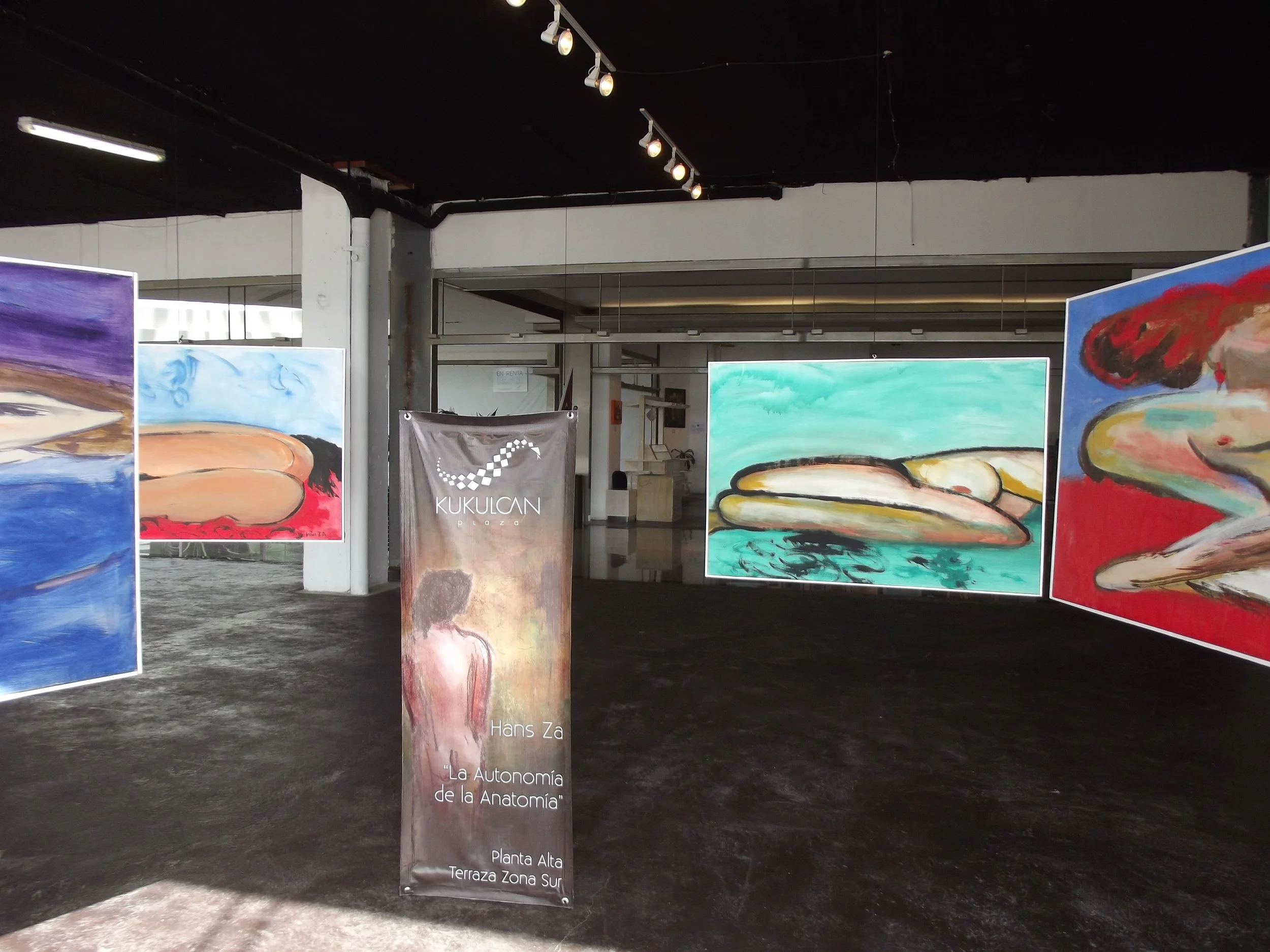 Installation view of Hans Zandvoort’s anamorphic paintings hanging at Plaza Kukulkán in Cancún, Mexico, allowing the works to be viewed from different angles.