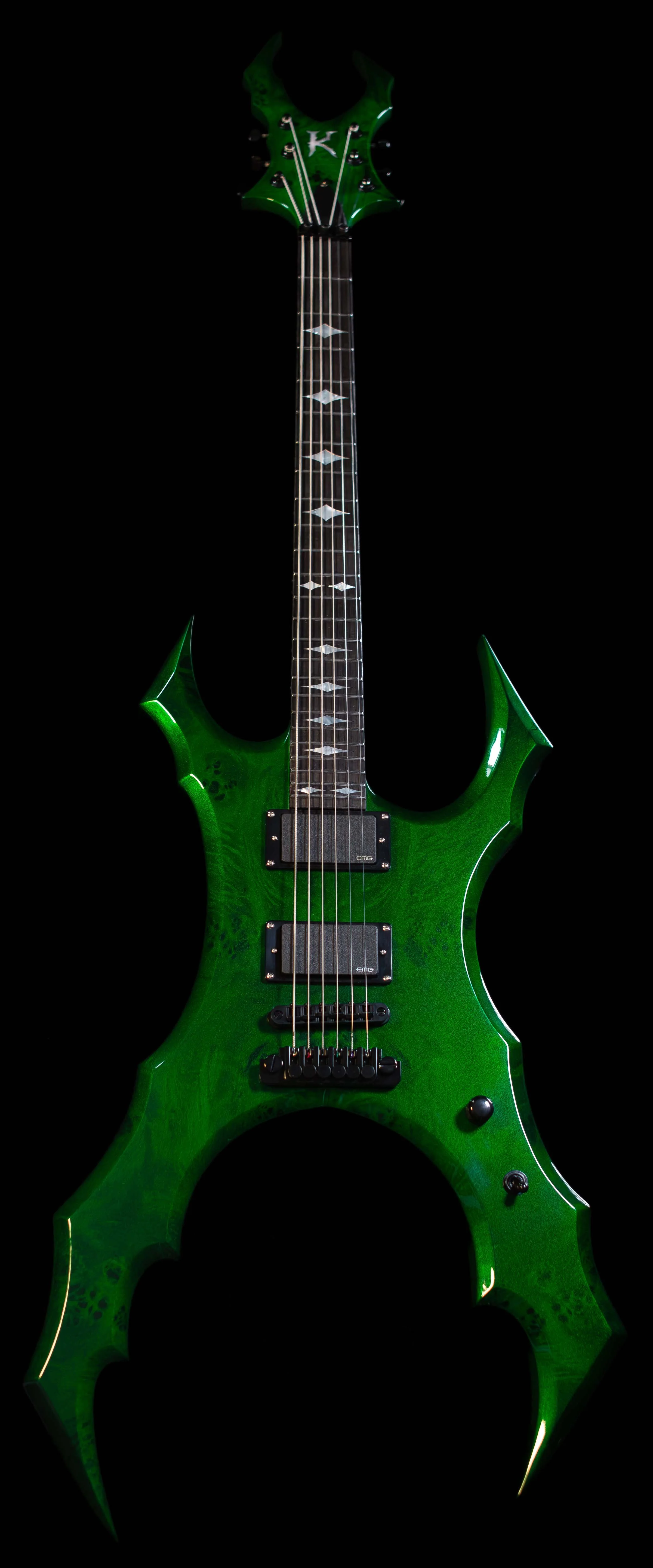 A green electric guitar with an edgy, spiky body design and black hardware, set against a black background.