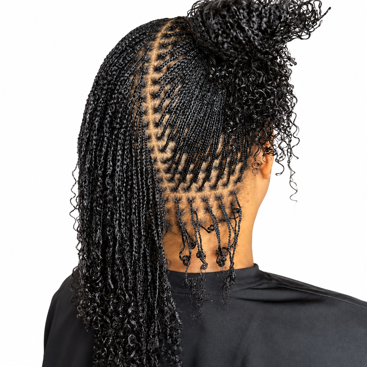 Back view of a woman with intricately styled black box braids and curly hair on the top right, wearing a black top, against a white background.
