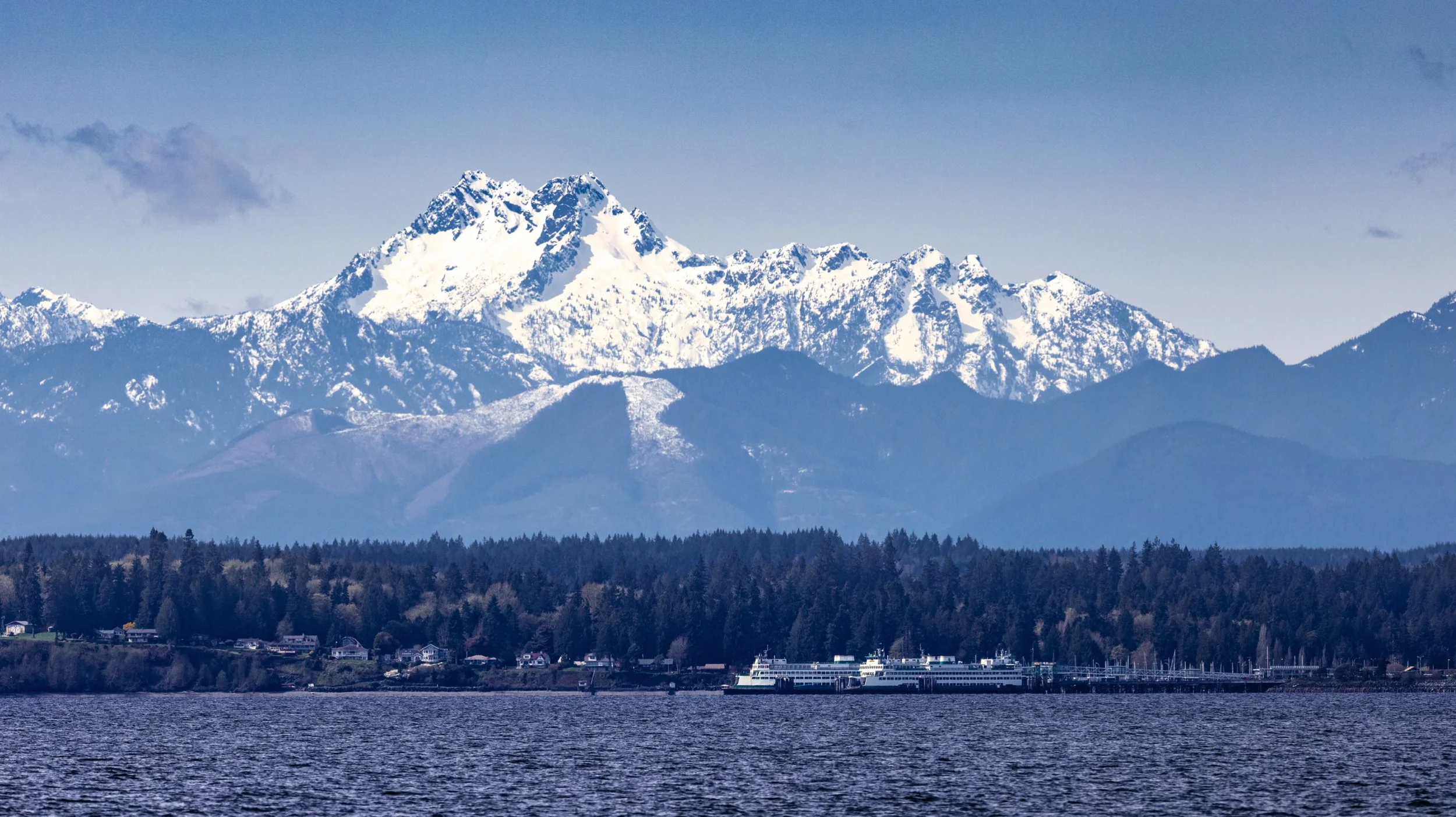 Snow-covered Olympic Mountains rising above Kingston as seen from the ferry leaving Edmonds Washington