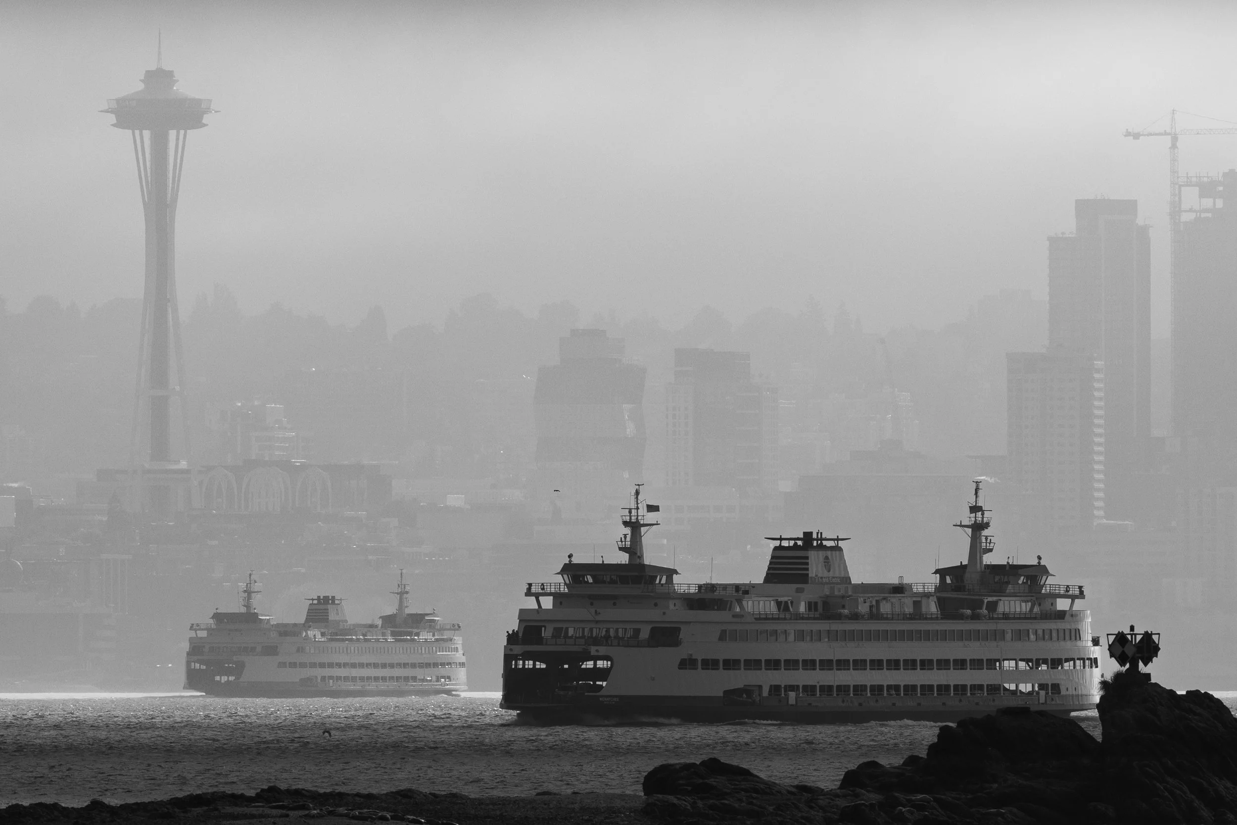 Black and white photo of the Washington State Ferry approaching Seattle from Bainbridge Island through the morning fog
