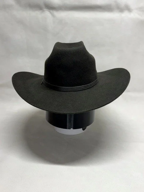 Black wide-brimmed cowboy hat on a display stand against a plain background.