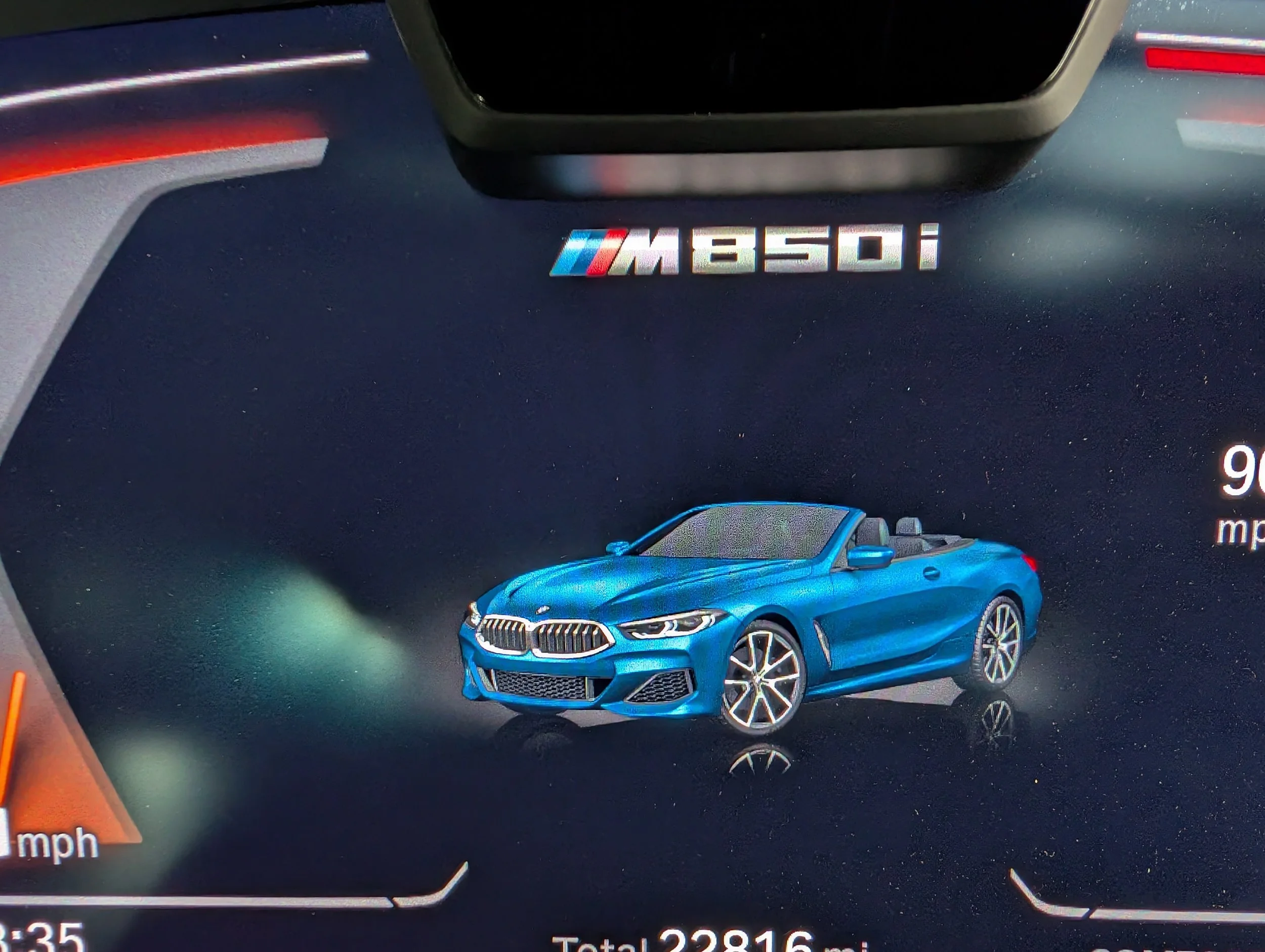 Blue BMW M340i car with M badge logo on a digital dashboard display, indicating speed and trip details.