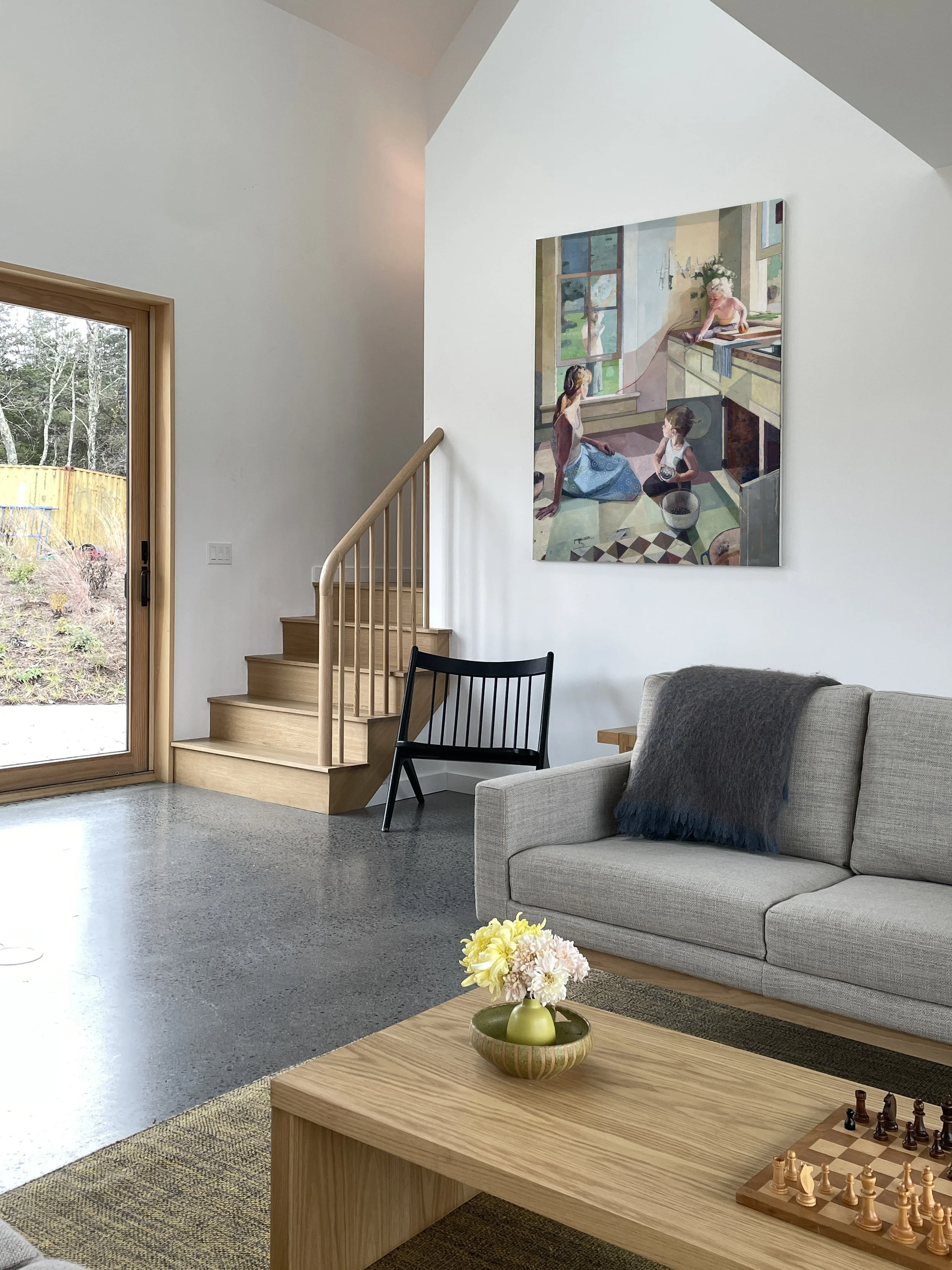 Is There Anything New? painting displayed on a living room wall above a sofa.