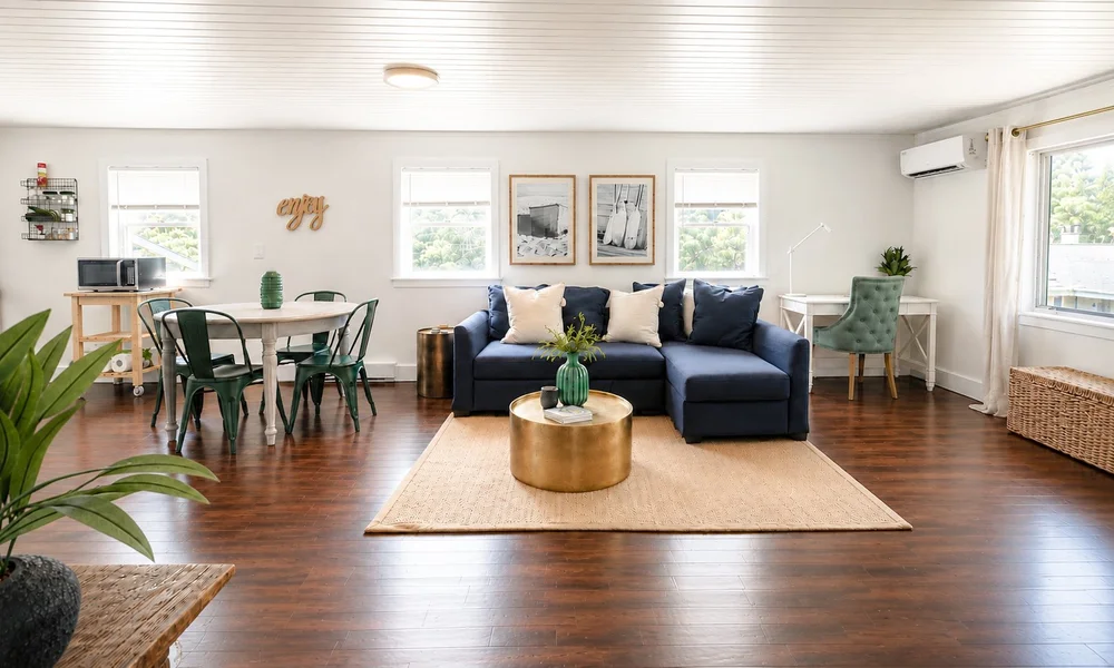 The bright open living and dining room of the Upper Deck carriage house.