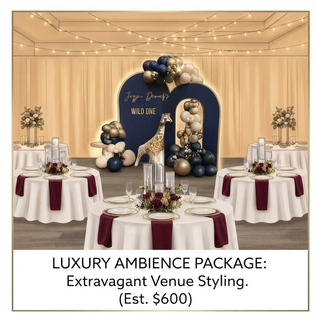 Elegant event space with round tables covered in white tablecloths and burgundy table runners, decorated with floral centerpieces and glassware. The background features a navy blue backdrop with gold and silver balloons and a giraffe sculpture, illuminated by string lights overhead. Signage indicates a luxury ambiance package.