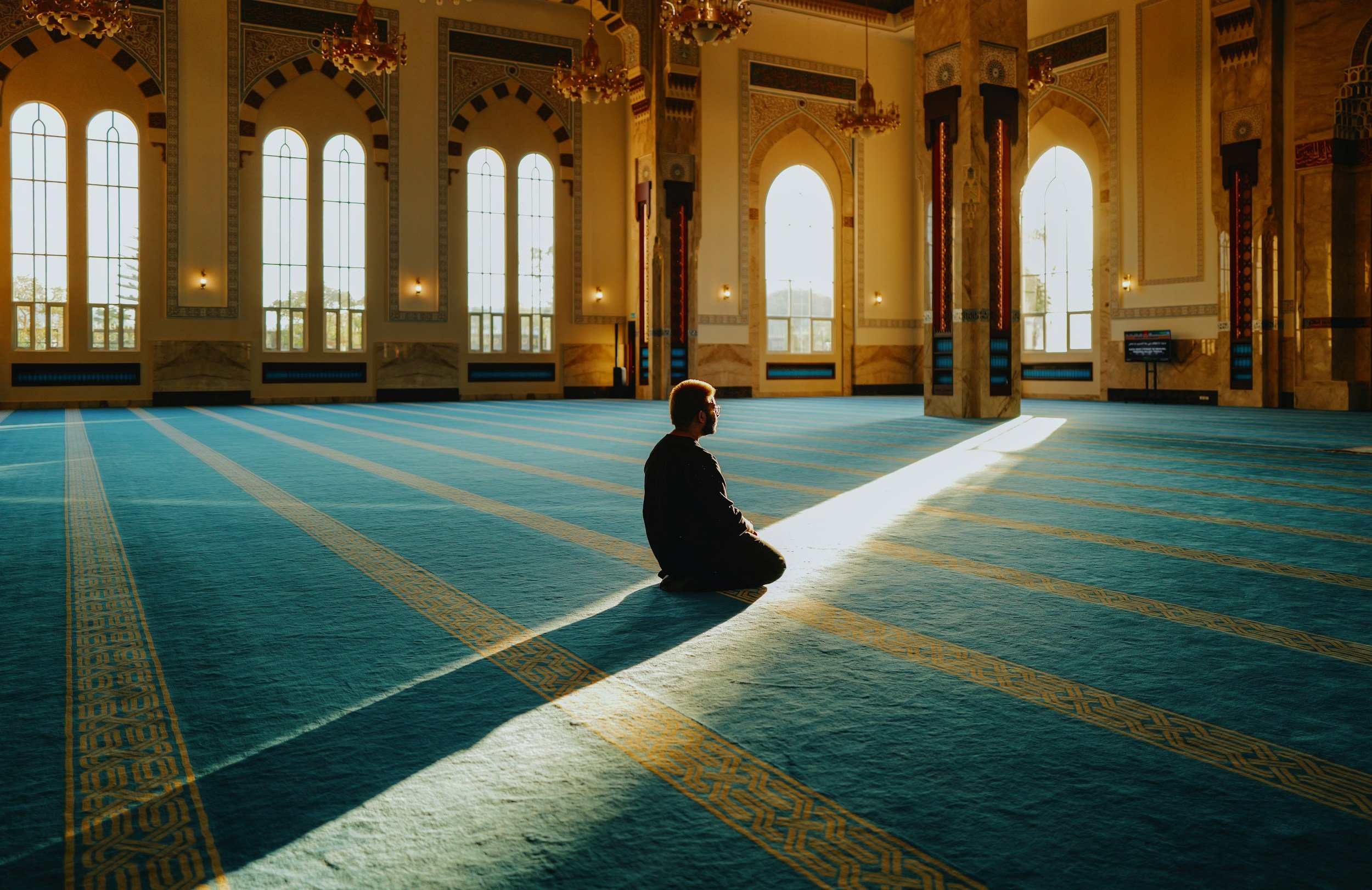 man praying mosque