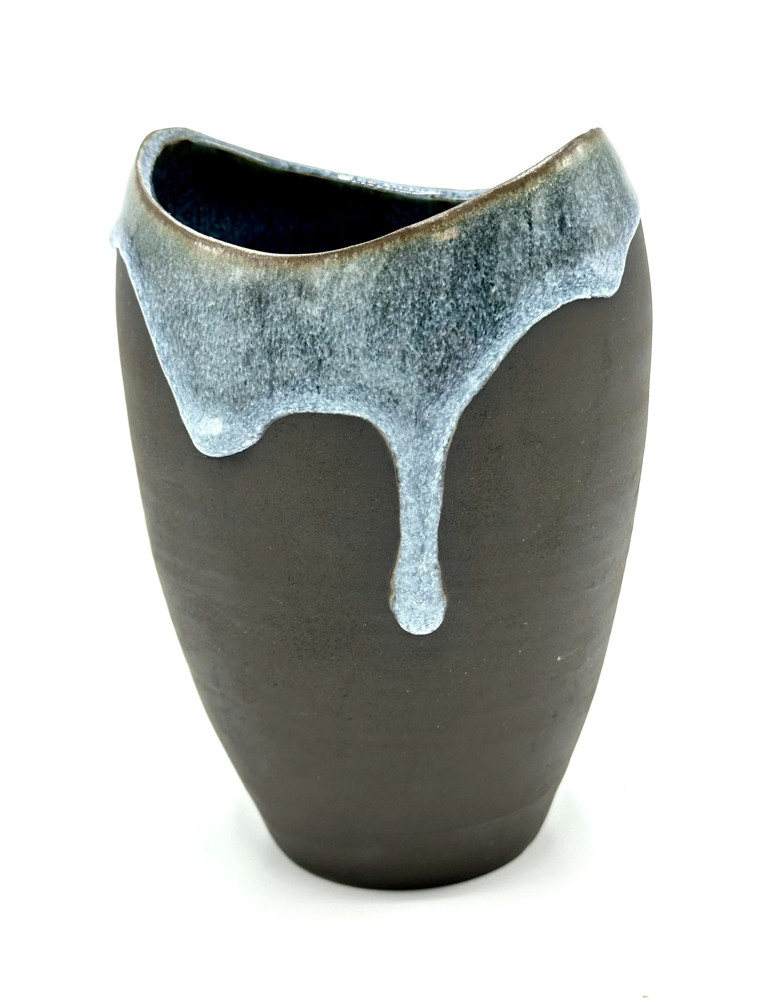 Close-up of a ceramic vase with a dark brown matte finish and a textured, light gray glaze dripping from the rim.
