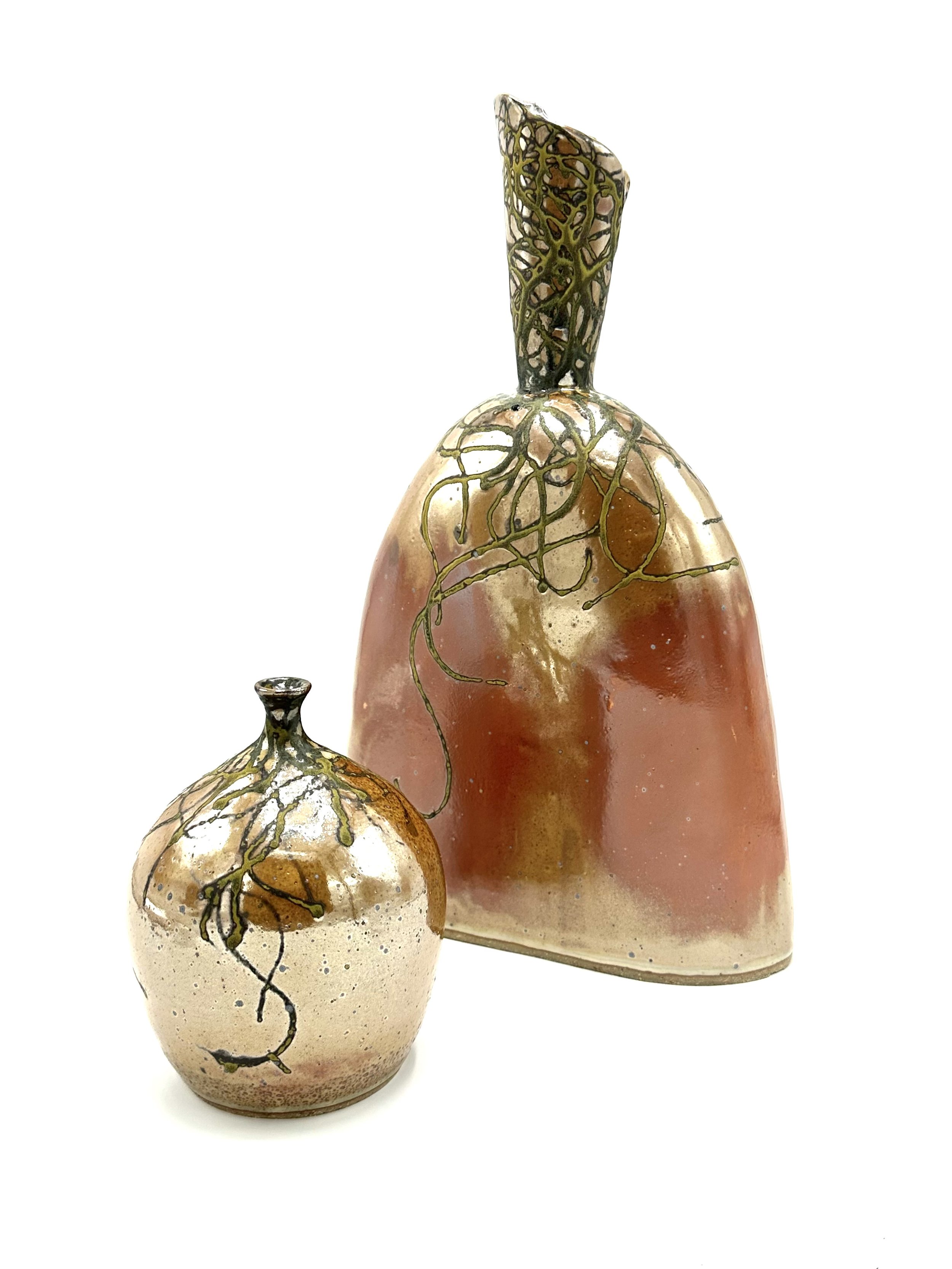 Two ceramic vases with a crackled pattern and golden vines, one smaller and round, the other taller and oval, against a white background.