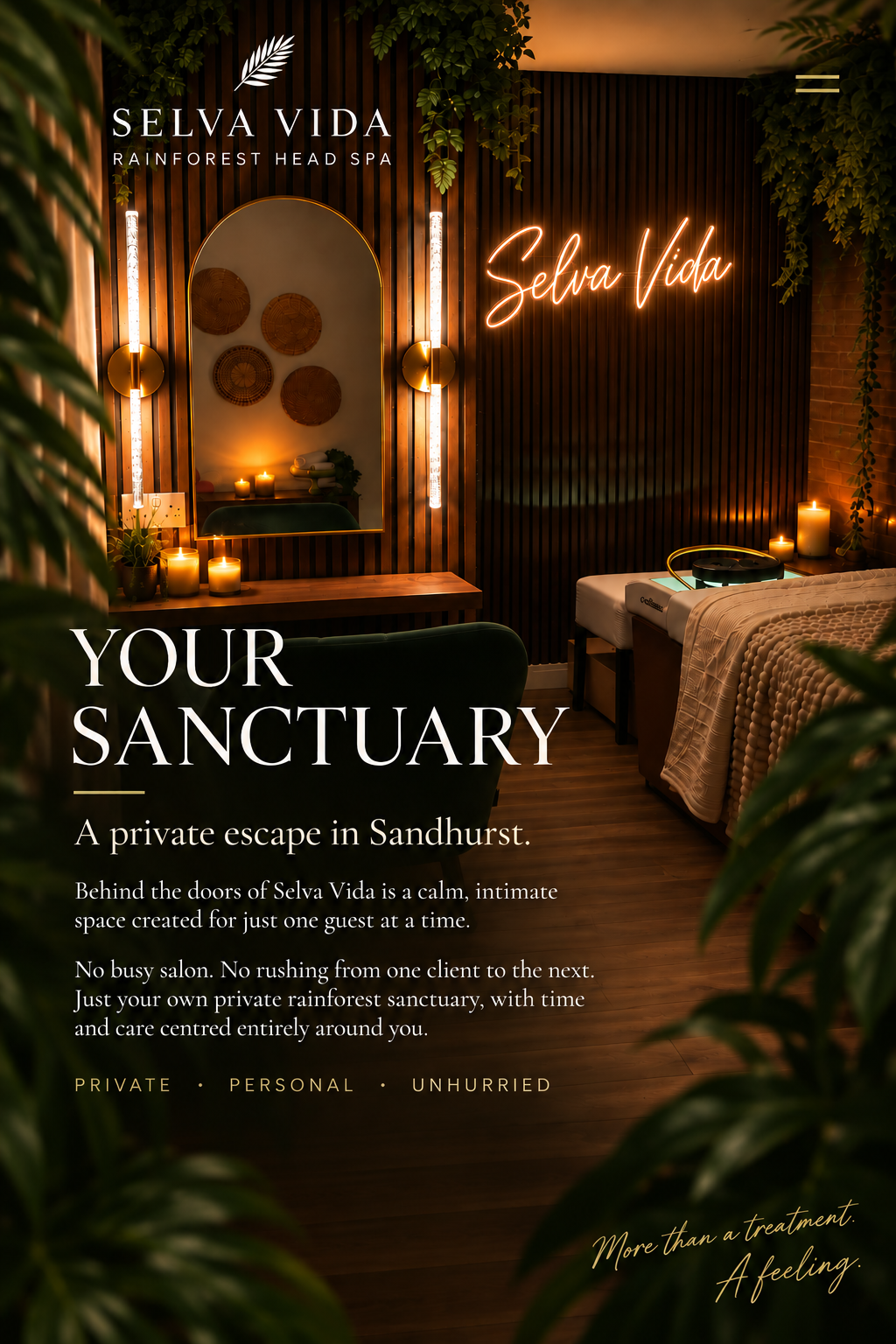 Selva Vida Rainforest Head Spa studio with treatment bed, tropical plants, candles and illuminated Selva Vida sign.
