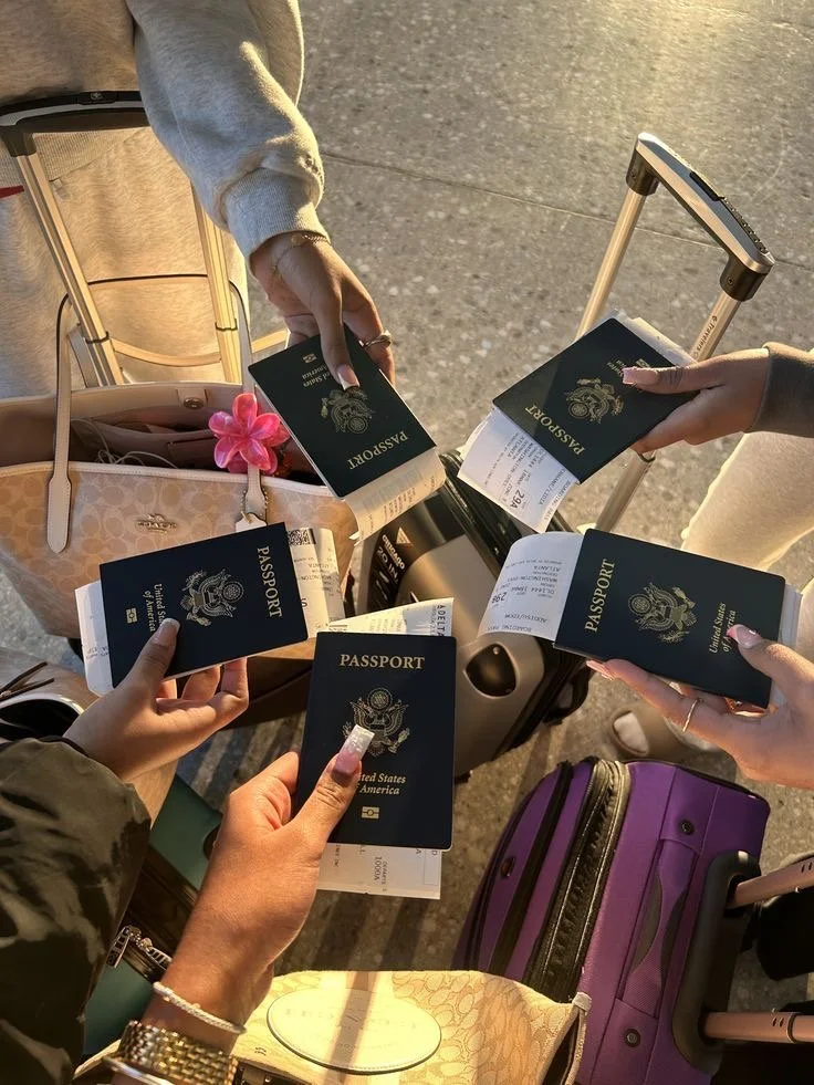 Multiple travelers holding U.S. passports and boarding passes, gathered around a luggage cart with suitcases.