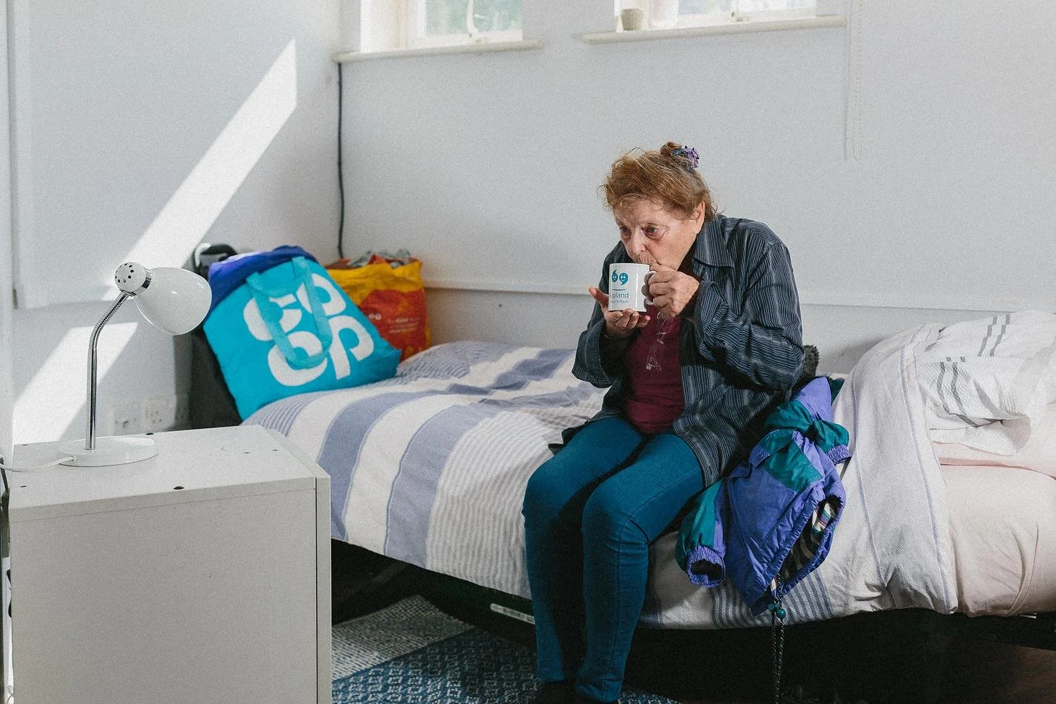 A woman drinking coffee from a cup.