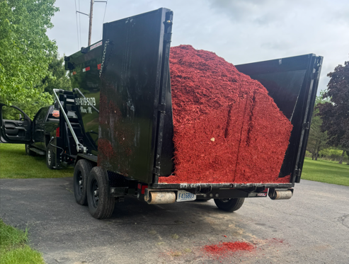 Loaded dumpster with mulch.png