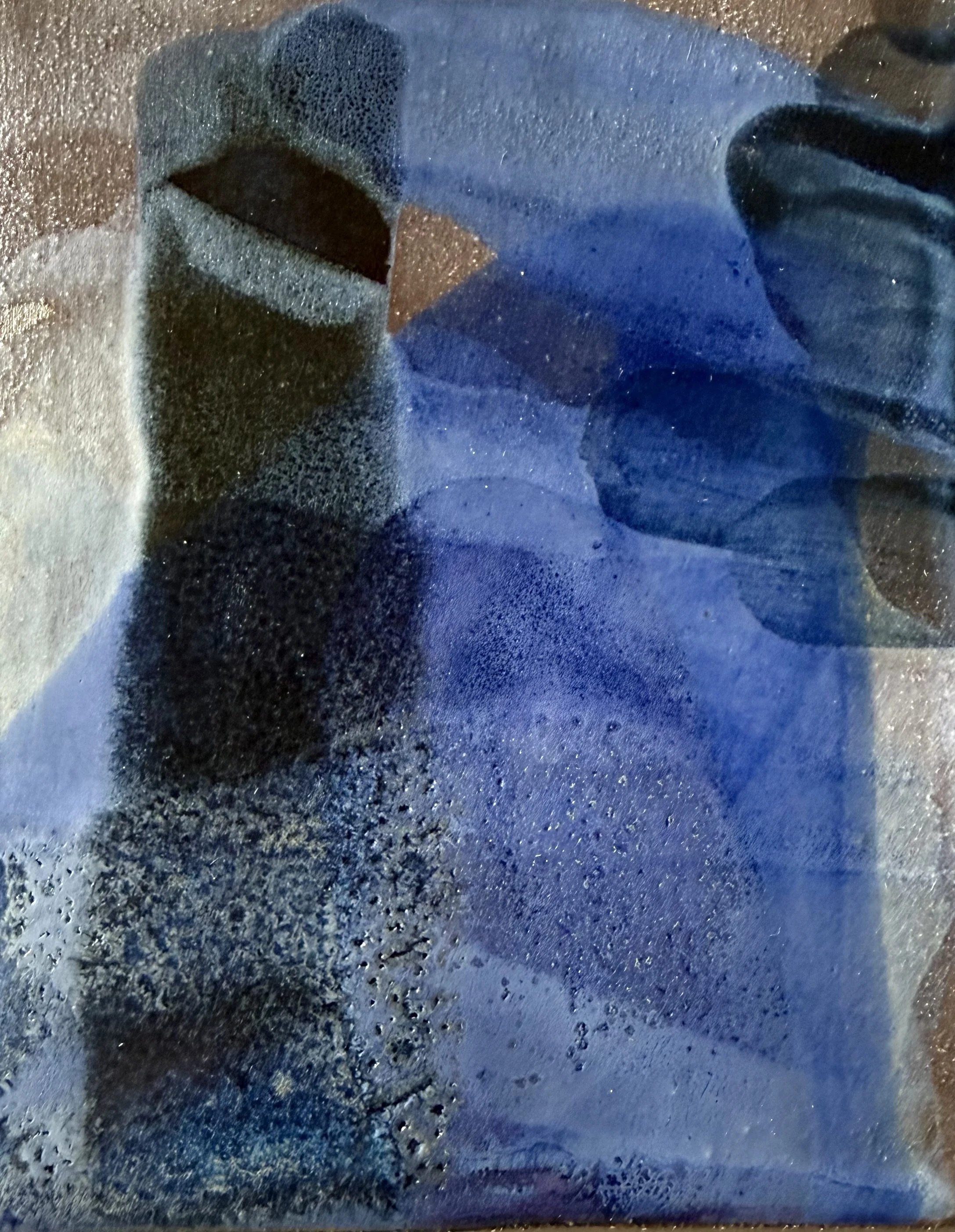 Close-up of a frosted window with water droplets, showing a blurry, shadowy silhouette of a person wearing dark clothing.