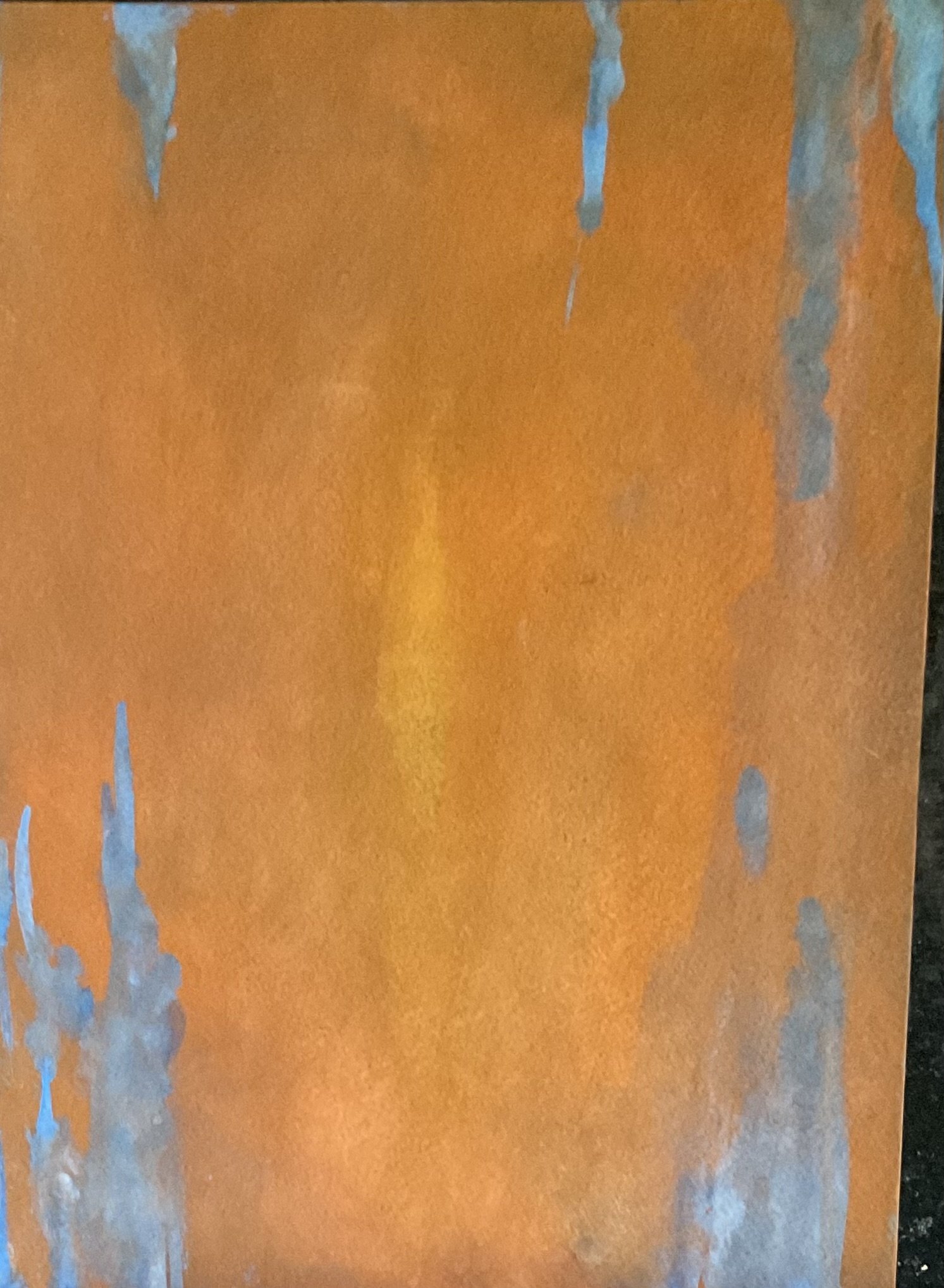 Close-up of a rusted metal surface with orange-brown paint peeling and chipping away, revealing gray metal underneath.