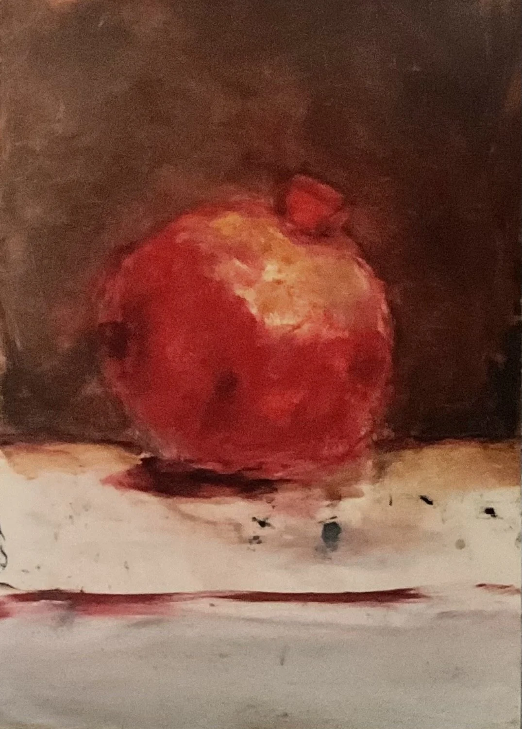 Painting of a pomegranate on a surface with a dark background.