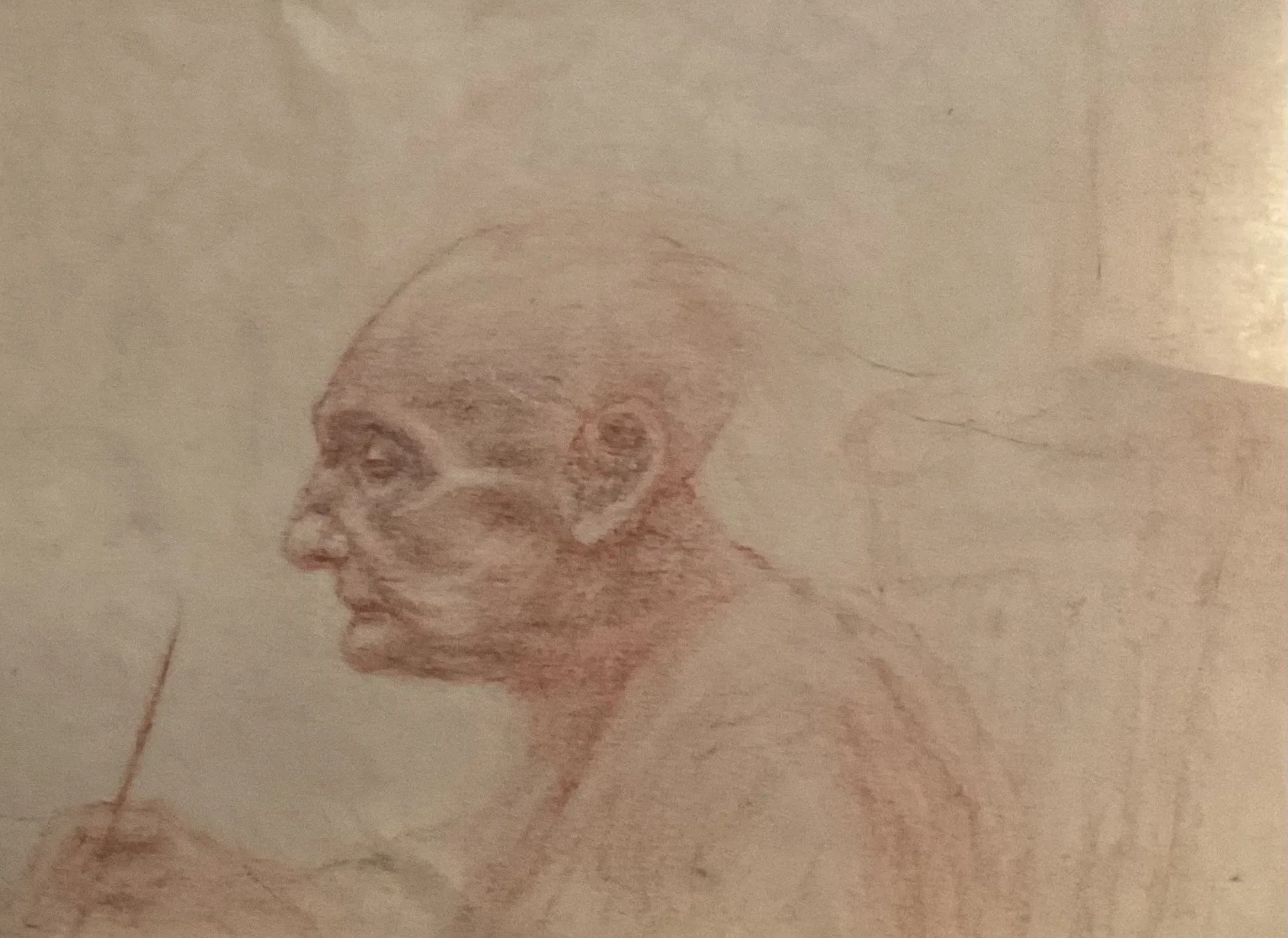 A colored pencil drawing of a person's face in profile, with visible shading and detail.