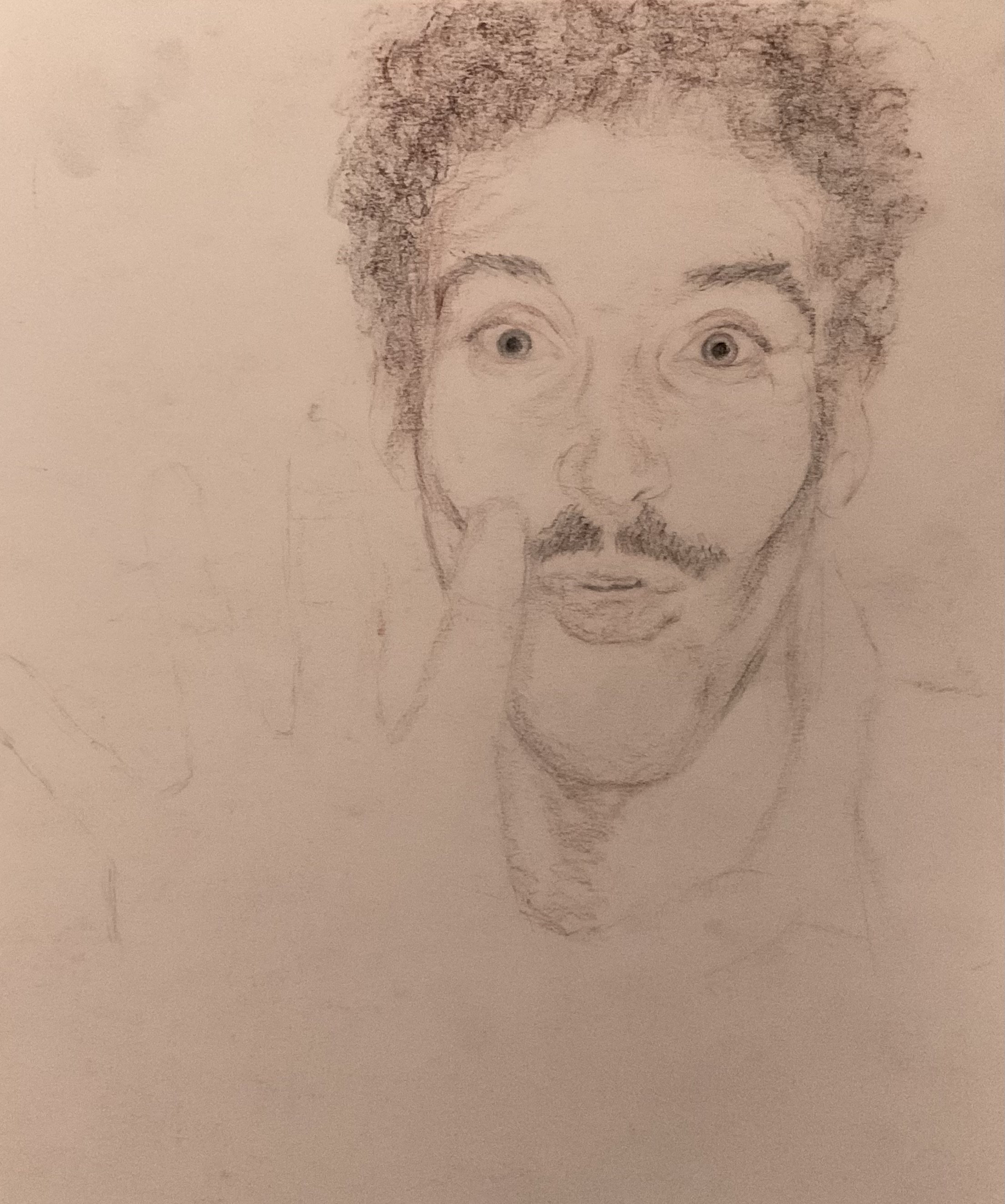 A rough sketch of a person's face, showing a man with curly hair, wide eyes, a mustache, and a beard, with a neutral expression.