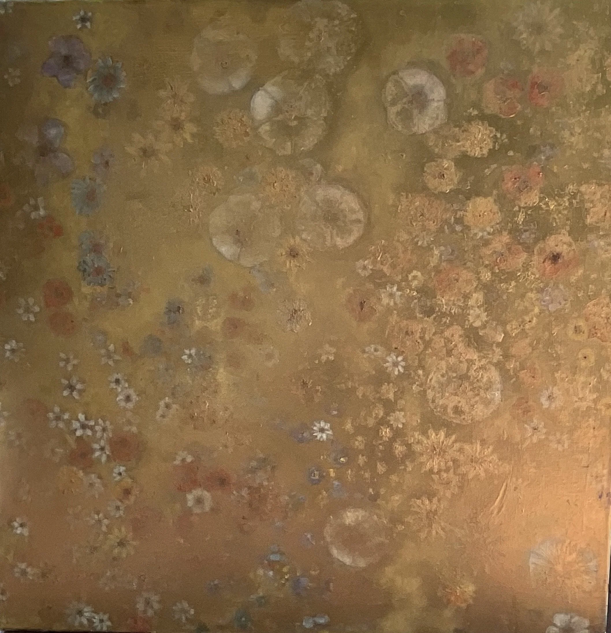 Close-up of a textured, light brown surface with small floral patterns and specks of various colors.