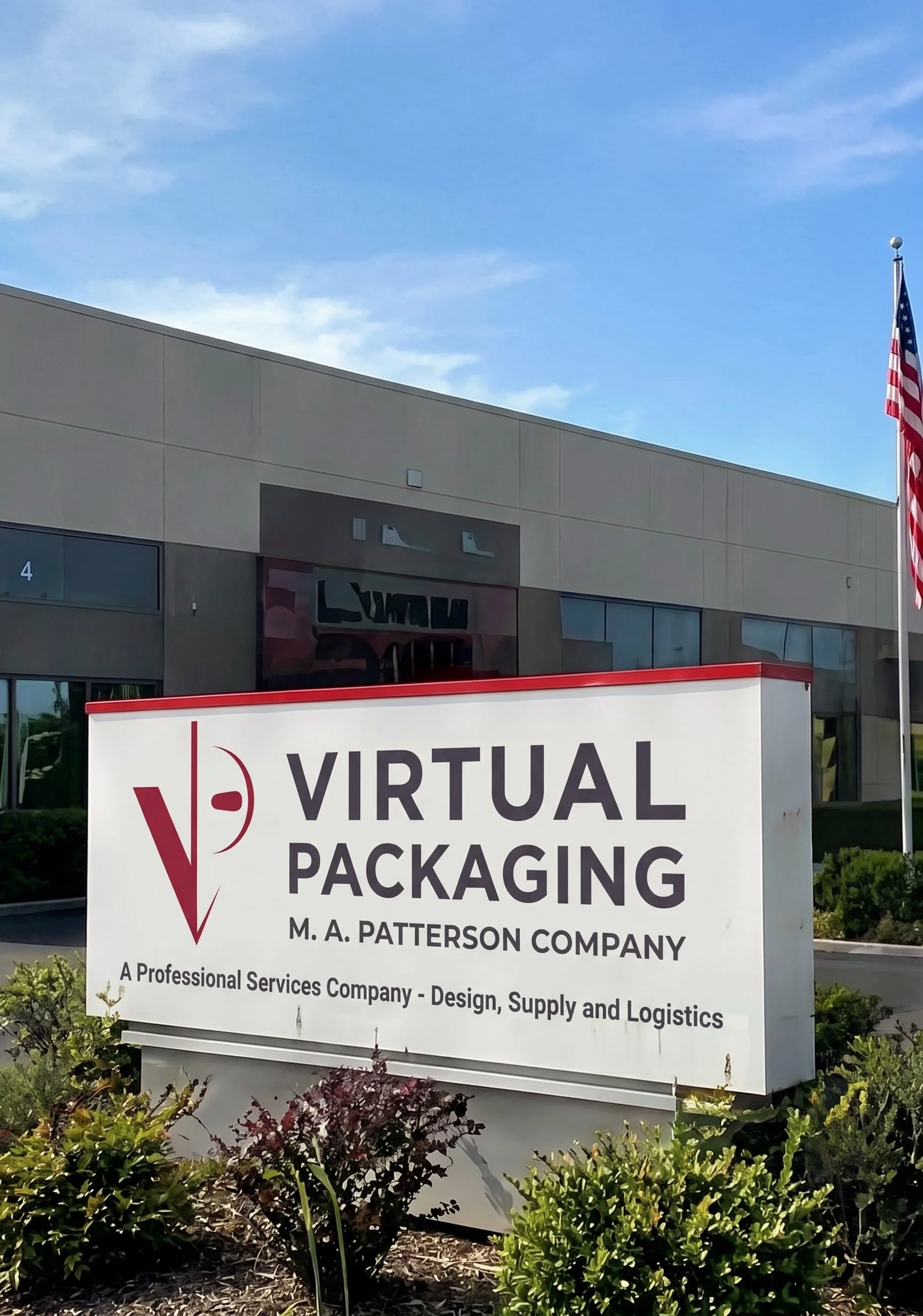 Sign for Virtual Packaging, a professional services company, located outside a building with American flags in the background, under a blue sky.