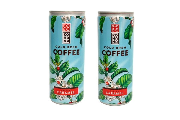 Two cans of KONA Cold Brew Coffee with caramel flavor, featuring a blue background and green leaves with white flowers on the label.