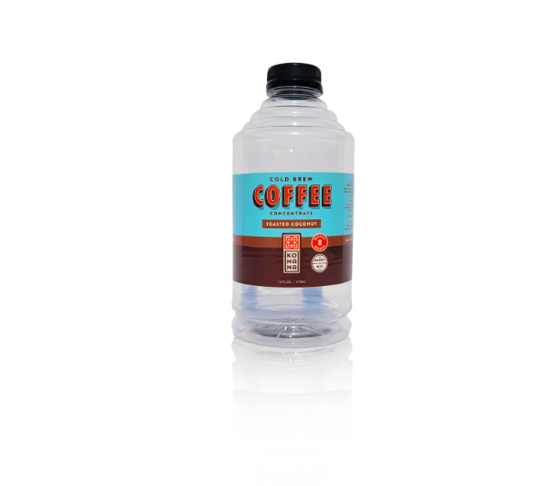 A clear plastic bottle of cold brew coffee concentrate with a black cap and a blue and brown label that reads "Cold Brew Coffee Concentrate Toasted Coconut."