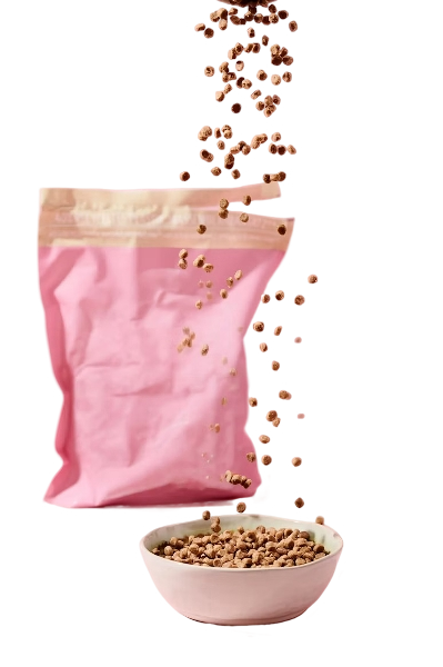 Pink resealable bag of dry pet food with some kibble spilling into a white bowl.