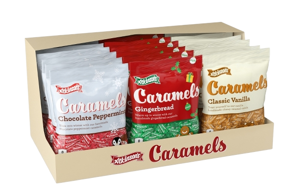 Assorted packages of Atkinson's caramel candies, including chocolate peppermint, gingerbread, and classic vanilla flavors, arranged in a wooden box.