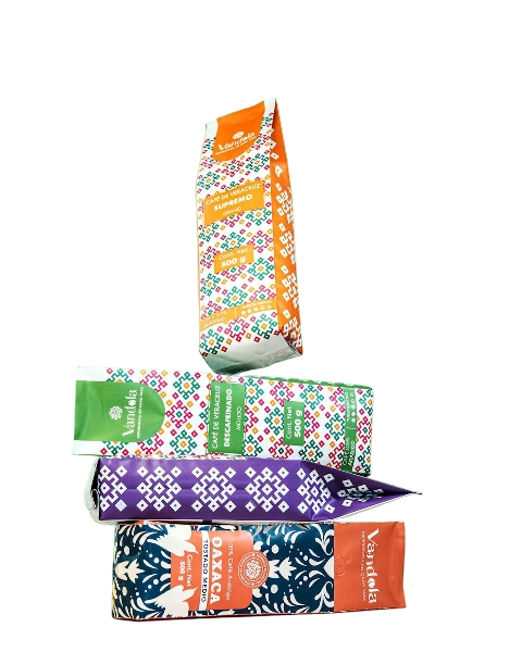 Four colorful packages of Mexican chocolate with traditional patterns and branding.