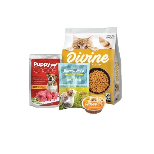 A collection of pet food products including a bag of Divine grain-free cat food, a smaller container of Divine cat food, a bag of Puppy Choice beef and gravy dog food, and a box of Murree & Co. turkey, sweet potato, and potato recipe dog food, with a bowl of dry cat food and a cat peeking over the bag of Divine cat food.