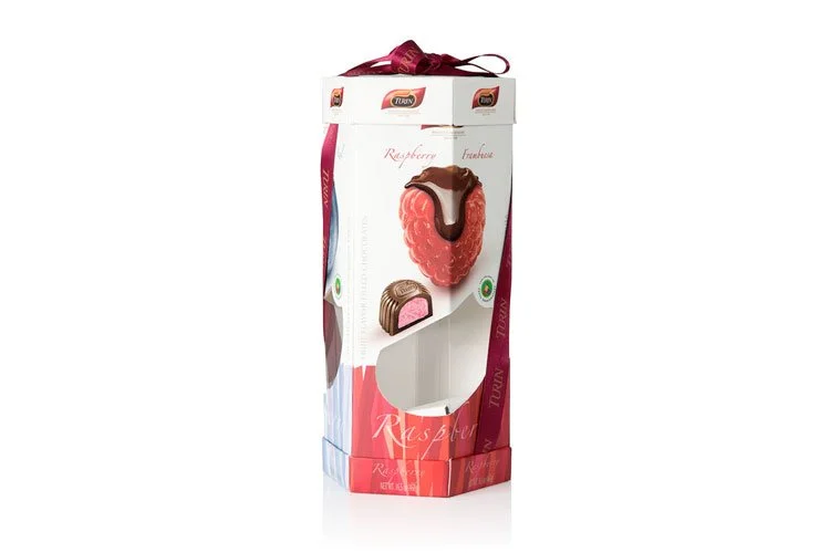 A tall, rectangular box of chocolate-covered raspberry and strawberry confections with a pink raspberry on the front.