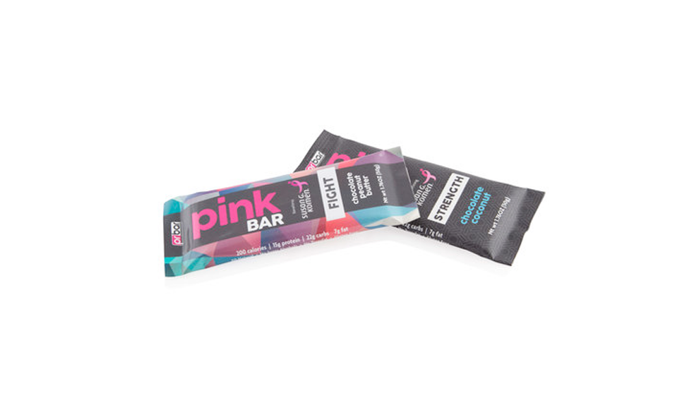 Pinkberry protein bar with black, pink, and blue packaging labeled 'Pink Bar' and flavor 'Chocolate Coconut'.