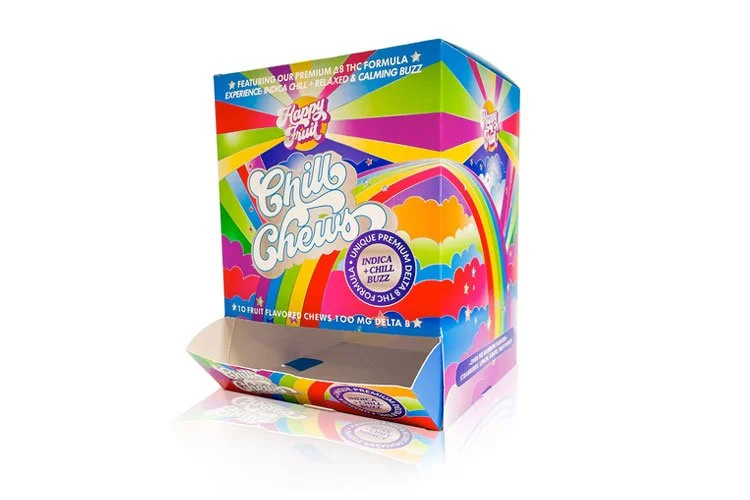Colorful display box of Happy Fruit Chill Chews, fruit-flavored chewy candies with a rainbow, clouds, and vibrant design.