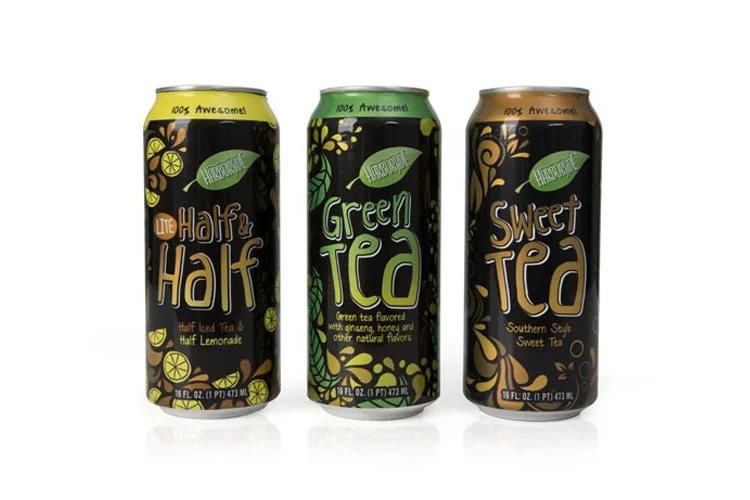 Three cans of flavored tea drink with black backgrounds and colorful graphics: The Half & Half, Green Tea, and Sweet Tea.