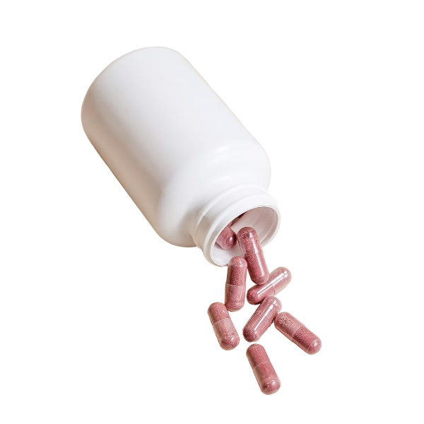 An open white supplement bottle with pink capsules spilling out.