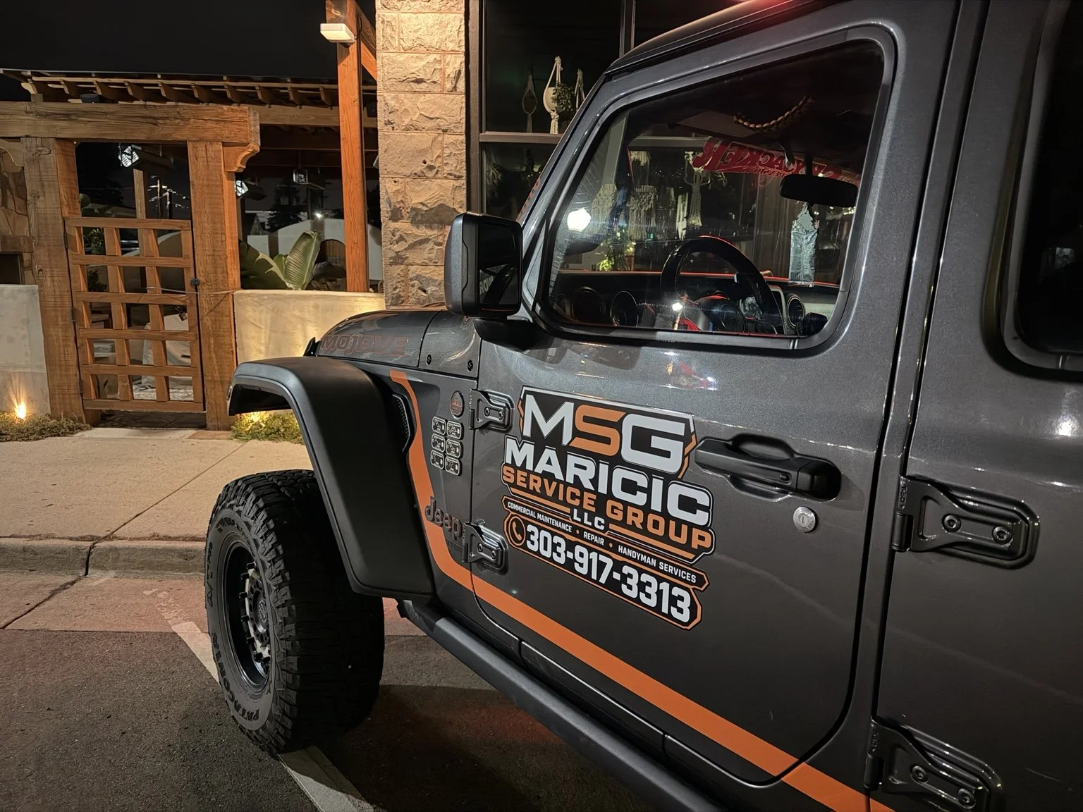 Original photo of the MSG branded Jeep showing the Maricic Services Group door decal in downtown Castle Rock.